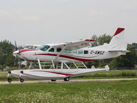 C-GMSZ @ YKZ - This 2011 Cessna 208 on floats has just landed on runway 15 at Buttonville Airport (YKZ) on a very overcast day. - by Ron Coates