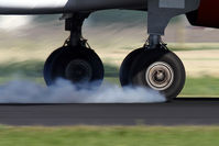 G-EZIS @ EHAM - smokey arrival - by Jeroen Stroes