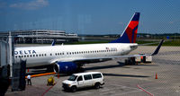 N392DA @ KDTW - Air hoses in place and baggage carts Gate A9 DTW - by Ronald Barker