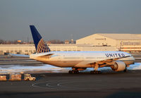N77012 @ KEWR - A newly painted ex-CO Boeing 777 makes her way to the taxiway on a cold January evening at Newark. - by Daniel L. Berek
