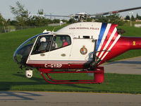 C-GYRP @ CYKZ - As this Police chopper hover taxied towards the runway the guy in the front left seat kept their white nose mounted camera aimed at me. So I smiled! - by Chris Coates