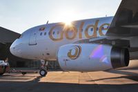 P4-PAS @ EGHH - Freshly painted..exits sprayshop into setting sun! - by John Coates