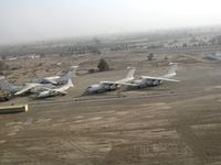 5A-DNC @ OMRK - 4 Il-76 and an An-12 at the airfield of Ras Al Khaimah (RKT) in the UAE - by Paul H