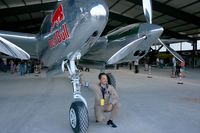 N25Y @ LFFQ - Raimund Riedmann flying bulls next  to the landing gear of Lockheed P-38L Lightning (N25Y), La Ferté-Alais Airfield (LFFQ) Air Show (Le Temps Des Hélices) in may 2012 - by Yves-Q