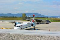 51 06 @ LOWG - Dash-8 in front of a Transall - by Paul H