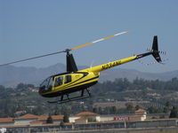 N234NL @ CMA - 2004 Robinson R44 RAVEN II, Lycoming IO-540-AE1A5 derated to 245 Hp for 5 minutes, 205 Hp continuous, departure with airshow riders - by Doug Robertson