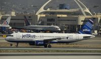 N594JB @ KLAX - Taxing to gate at LAX - by Todd Royer
