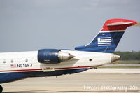 N915FJ @ KSRQ - US Air Flight 2884 operated by Mesa (N915FJ) departs Sarasota-Bradenton International Airport enroute to Charlotte-Douglas International Airport - by Donten Photography