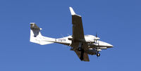 C-FGTV @ CYXX - Landing... side view - by Guy Pambrun
