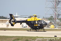 VP-CPS @ KSRQ - Grand Cayman Police Department helicopter (VP-CPS) on the ramp at Rectrix - by Donten Photography