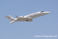 N22AX @ KSRQ - Learjet 45 (N22AX) departs Sarasota-Bradenton International Airport enroute to Burlington Airport - by Donten Photography