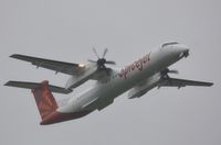 VT-SUO @ EGHH - Wet departure on delivery - by John Coates
