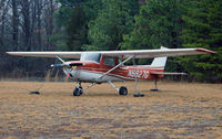 N6827G @ KMIV - A soaked Cessna 150 sinks into the soggy grass at Millville. - by Daniel L. Berek