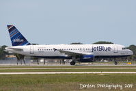 N648JB @ KSRQ - JetBlue Flight 164 (N648JB) That's What I Like About Blue departs Sarasota-Bradenton International Airport - by Donten Photography