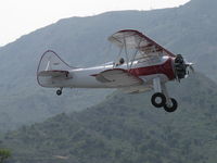 N32135 @ SZP - 1941 Waco UPF-7, Continental W670 220 Hp, stunning showplane with chromed prop, radial engine, arguably one of the prettiest classic biplanes, takeoff climb Rwy 22 - by Doug Robertson