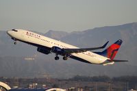 N808DN @ KLAX - Delta Airlines 737-900ER with the Hollywood sign in the background.