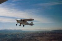 N5248Z - 48Z in slow flight over the south side of the Livermore Valley in Calif. The SF Bay Area is seen in the distance.       1986
