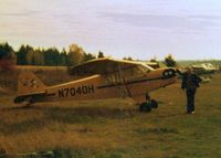 N7040H @ UNKN - Ed Brown with his 1946 J-3 in the 1980's. Bought in 1963 for $1300. - by Steve Brown