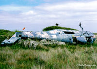 XP160 @ EGDO - Scanned from print. Remains of Wessex HAS.1 XP160 at the fire training school, RNAS Predannack (EGDO). Ex School of Aircraft Handling at nearby Culdrose, with the code SAH-24 - by Clive Pattle