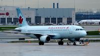 C-FKOJ @ CYYZ - Air Canada Airbus A320 on a rainy early morning.