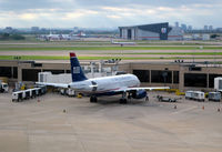 N824AW @ KDFW - Gate E27 DFW  First Officer preflighting engine number 2. - by Ronald Barker