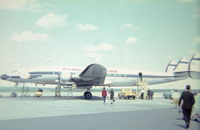 N45515 - N5515 on the tarmac at Gander, Newfoundland refueling on a charter flight from Prestwick, Scotland to New York in 1964,  Flying Tiger Lines operated this aircraft as a cargo plane but it could be fitted with metal frame canvas seats for charter flights. - by James Findlay