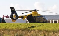 G-WONN @ EGFH - South Wales and Gwent Police Air Support Unit helicopter visiting the Wales Air Ambulance base at Swansea Airport. The mid-Wales Air Ambulance helcopter G-WASC can be seen departing for it's Welshpool Airport base - by Roger Winser