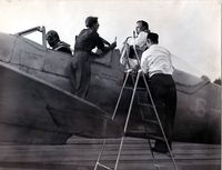 G-AIDN - The Hampshire Aero Club based at Eastleigh Aerodrome used to race a training Spitfire (G-AIDN). This photo was taken at Villacoublay airfield south of Paris as the crew prepare to return to Biggin Hill after the London - Paris air race. Pilot is Mr V Bell - by Bern Byrne