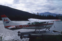 SE-GXT @ N.A. - Cessna TU206 on floats on the river Kamajåkk at Kvikkjokk in Swedish Lappland. - by Henk van Capelle