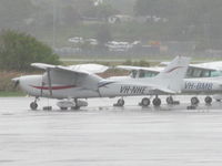 VH-NHE @ YBCG - on a very wet GA ramp - by magnaman