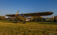 N57560 @ KOSH - ’43 J-3C sitting in the Warbird Liaison/Observation ramp at Oshkosh 2014. - by Mike Lambert