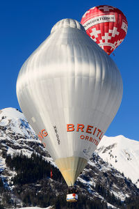 HB-QGF - Orbiter together with HB-QMS 'Swiss Meat' over famous Château-d'Oex village near Gstaad - by Grimmi
