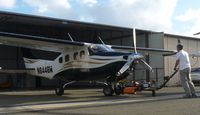 N6446W @ KRHV - Pushing back a beautiful Pressurized Cessna 210 into it's hangar. - by Chris L.