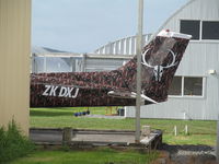 ZK-DXJ @ NZAR - spotted between hangars with what looks like a newly painted reg and fancy background!! - by magnaman