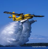 C-FOPJ - Carl Hanssen dropping a load of water - by Bush planes north