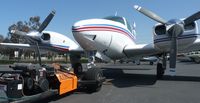 N427KM @ KRHV - A 1974 Beechcraft Baron 55 waiting to be towed back into the Lafferty Aircraft Sales hangar. - by Chris L.