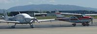 N422TB @ KRHV - A transient 2006 Cirrus SR22 with a transient Cessna T206 next to it. - by Chris L.