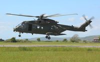 ZJ129 @ EGFP - Visiting RN Merlin helicopter coded N of 846 NAS departing the airport after taking on fuel. The helicopter still carries the badge of the disbanded 78 Squadron RAF on the port side of the boom. - by Roger Winser