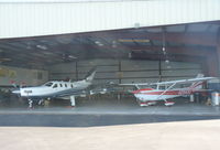 N2943U @ KAPC - A 1963 Cessna 172D sitting inside a hangar next to a local TBM 850 at Napa Airport, CA. - by Chris Leipelt