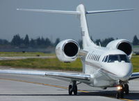 N945QS @ KSJC - A 1997 Cessna Citation X (NetJets Aviation) taxing out of the Atlantic FBO getting ready to depart San Jose International Airport, CA. - by Chris Leipelt