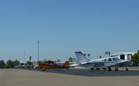 N1835B @ KRHV - A transient 1977 Beechcraft Baron 55 (Grass Valley, CA) visiting Reid Hillview Airport, CA with an overview of transient parking. - by Chris Leipelt