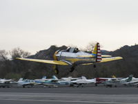 N4995C @ SZP - 1949 North American T-6G TEXAN 'Thirsty Girl', 1949 factory reman, P&W R-1340 600 Hp, takeoff climb Rwy 04, gear in transit, will do commemoration flour bombing of river target on anniversary of 7 Dec. 1941 Pearl Harbor attack. - by Doug Robertson