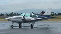 N333W @ KRHV - A transient 1979 Beechcraft Baron E-55 (GRECMAR AIR INC - WILMINGTON, DE) sitting at the transient ramp in between rainstorms at Reid Hillview Airport, CA. - by Chris Leipelt