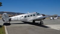 N118SA @ E16 - A privately owned 1954 Beech E18S (INDEPENDENCE, OR) parked at the Magnum Aviation Ramp for maintenance at South County Airport, CA. It was once a local flyer in San Jose, CA until the owner moved to Oregon. - by Chris Leipelt