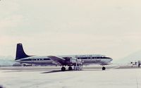 D-ABAC @ HKG - Ramp crew awaiting transportion to the ramp at HKG Kai Tak airport.Under a Sudflug DC-7C for shade.