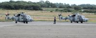 ZZ515 @ EGFH - Wildcats ZZ396 and ZZ515 of the Royal Navy Helicopter Display Team Black Cats preparing to depart the airport and display on the second day of the Wales National Airshow 2015. - by Roger Winser
