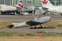 G-BRKD @ CYVR - Better days seen. In the outer field at CYVR by another shell, likely used for Emergency rescue practices. Apologies for the poor quality of the image, I was shooting through badly scratched windows of another craft. - by Remi Farvacque