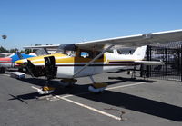N7463T @ KRHV - Locally-based 1959 Cessna 172A (with bottom engine cover removed) getting maintenance at Nice Air at Reid Hillview Airport, San Jose, CA. - by Chris Leipelt