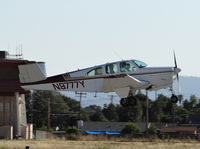 N9777Y @ KRHV - Locally-based 1963 Beechcraft P35 Bonanza departing runway 31R at Reid Hillview Airport, San Jose, CA. - by Chris Leipelt