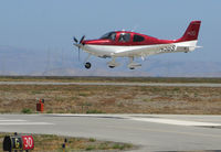 N345BS @ KSQL - Locally-based 2010 Cirrus SR20 over the threshold @ San Carlos Airport, CA - by Steve Nation